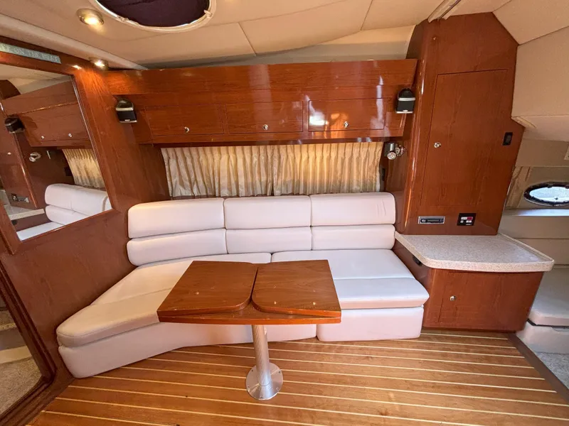 Slide: The Image of 2006 Regal Commodore 3560 IO yacht interior with white seating and wooden accents. - 40