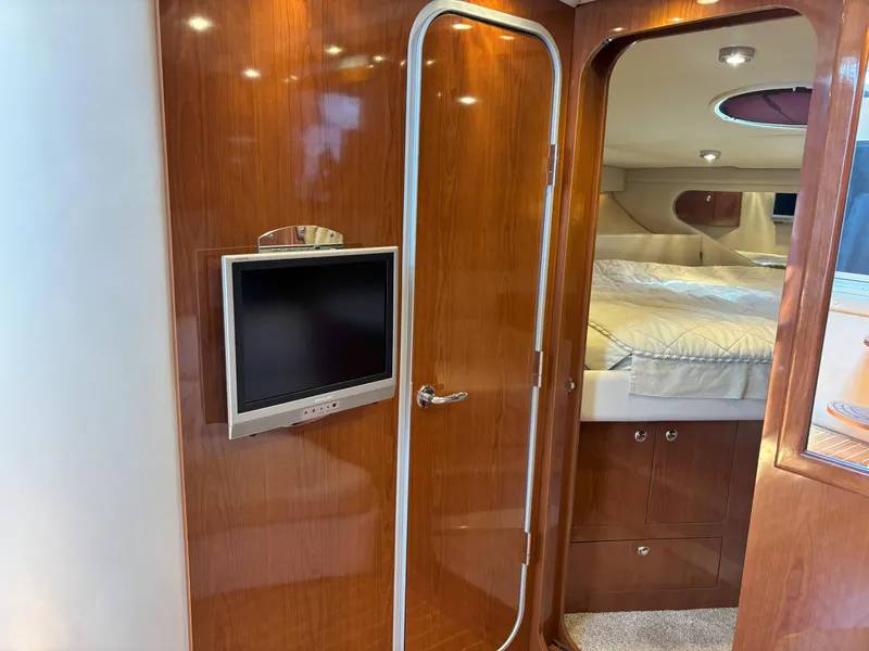 Slide: The Image of Interior of 2006 Regal Commodore 3560 IO yacht with wood paneling and bedroom view. - 44