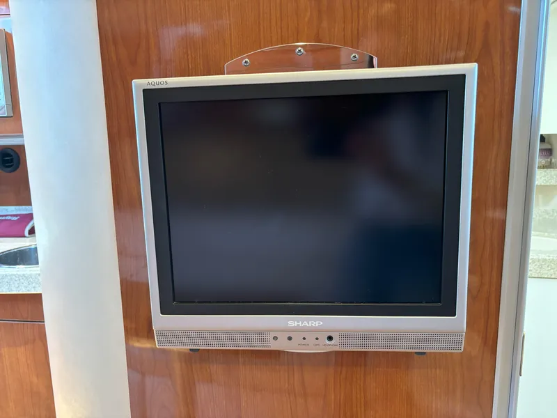 Slide: The Image of Sharp Aquos TV mounted on wood panel inside 2006 Regal Commodore 3560 IO boat. - 45