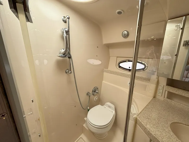 Slide: The Image of 2006 Regal Commodore 3560 IO yacht bathroom with shower, toilet, and porthole window. - 47