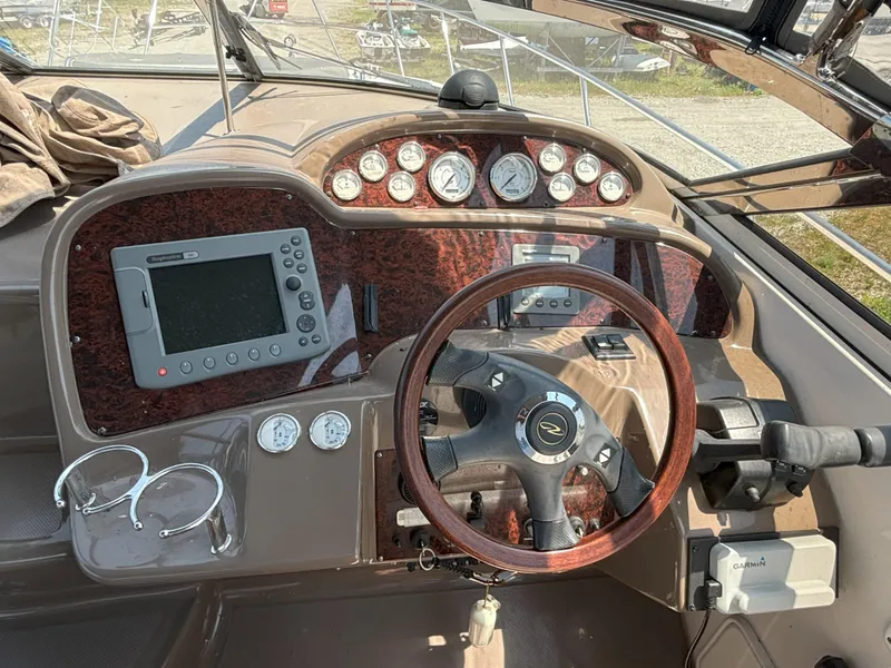 Slide: The Image of 2006 Regal Commodore 3560 IO helm with wood steering wheel and navigation instruments. - 7