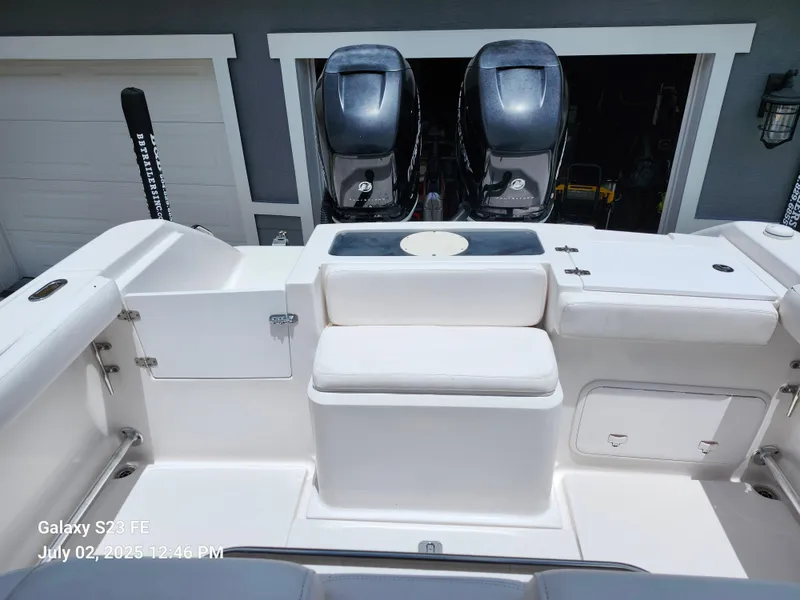 Slide: The Image of 2010 Donzi 29ZF boat interior with dual engines, parked near a garage. - 13