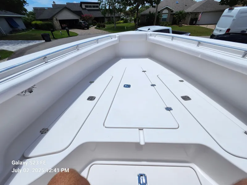 Slide: The Image of 2010 Donzi 29ZF boat dashboard with steering wheel and controls, parked in a residential area. - 17