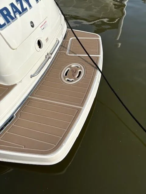 Slide: The Image of 2008 Sea Ray 270 Amberjack swim platform with teak-style decking, docked on calm water. - 10