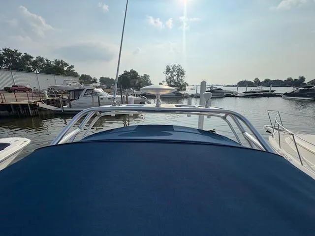Slide: The Image of 2008 Sea Ray 270 Amberjack boat docked at a marina under a sunny sky. - 12