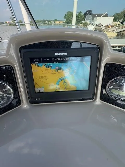 Slide: The Image of Dashboard of 2008 Sea Ray 270 Amberjack with Raymarine navigation display. - 2