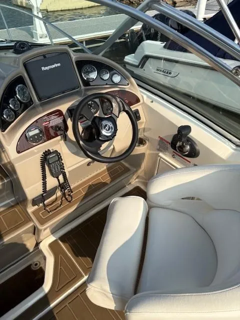 Slide: The Image of 2008 Sea Ray 270 Amberjack boat cockpit with steering wheel and control panel. - 3