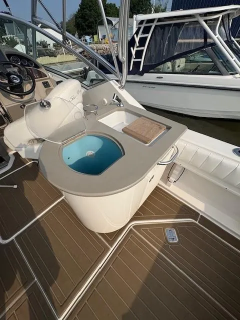 Slide: The Image of 2008 Sea Ray 270 Amberjack boat interior with sink and seating area. - 9