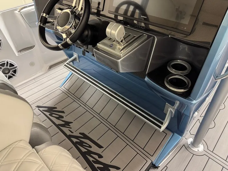 Slide: The Image of 2024 Nor-Tech 390 Sport Center Console helm with steering wheel, controls, and cup holders. - 11