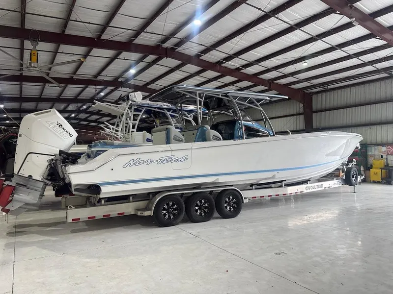 Slide: The Image of 2024 Nor-Tech 390 Sport Center Console boat in a warehouse on a trailer. - 15