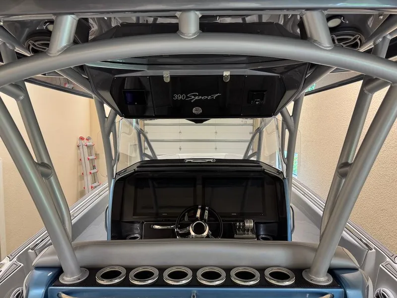 Slide: The Image of 2024 Nor-Tech 390 Sport Center Console interior with steering wheel and control panel. - 16