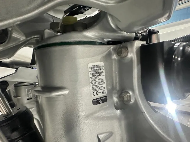 Slide: The Image of Close-up of 2024 Nor-Tech 390 Sport Center Console engine component with label and bolts. - 25