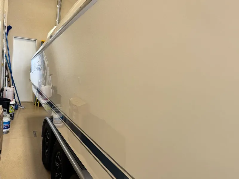 Slide: The Image of 2024 Nor-Tech 390 Sport Center Console boat in storage, side view. - 26