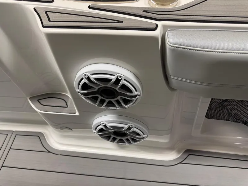 Slide: The Image of 2024 Nor-Tech 390 Sport Center Console interior with speakers and cushioned seating. - 5