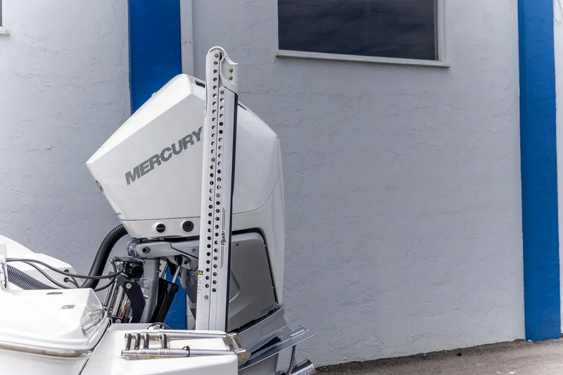 Slide: The Image of 2025 Crevalle 24 HCO boat with Mercury outboard motor near a blue and white wall. - 10