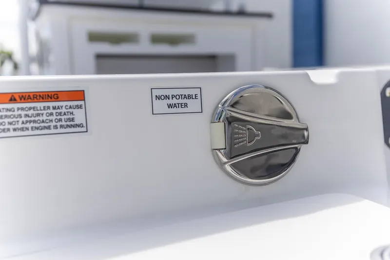 Slide: The Image of Non-potable water access on 2025 Crevalle 24 HCO boat with safety warning label. - 13