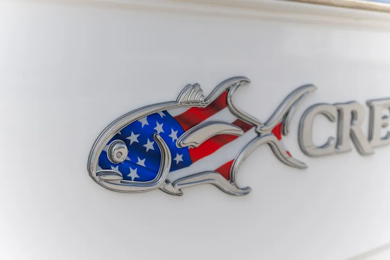 Slide: The Image of American flag fish emblem on 2025 Crevalle 24 HCO boat. - 16