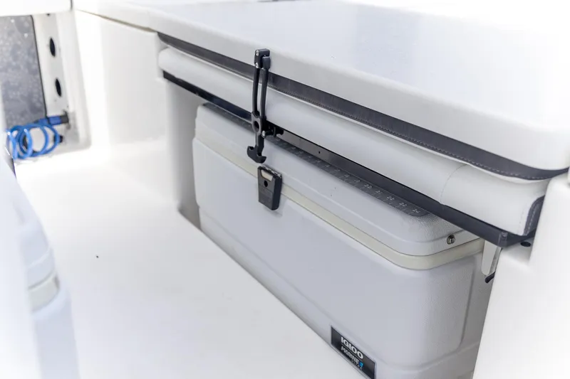 Slide: The Image of 2025 Crevalle 24 HCO boat interior with secured Igloo cooler. - 19