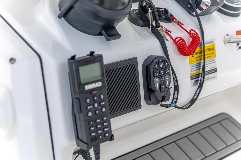 Slide: The Image of Control panel of 2025 Crevalle 24 HCO boat with Simrad device and safety features. - 22