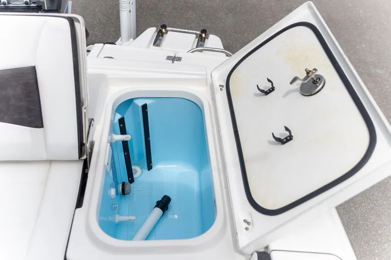 Slide: The Image of Open storage compartment on 2025 Crevalle 24 HCO boat, featuring blue interior. - 32