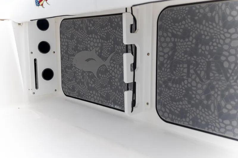 Slide: The Image of 2025 Crevalle 24 HCO boat interior with patterned storage compartments and rod holders. - 35