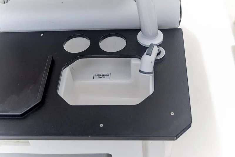 Slide: The Image of Crevalle 24 HCO 2025 boat sink with non-potable water label. - 38