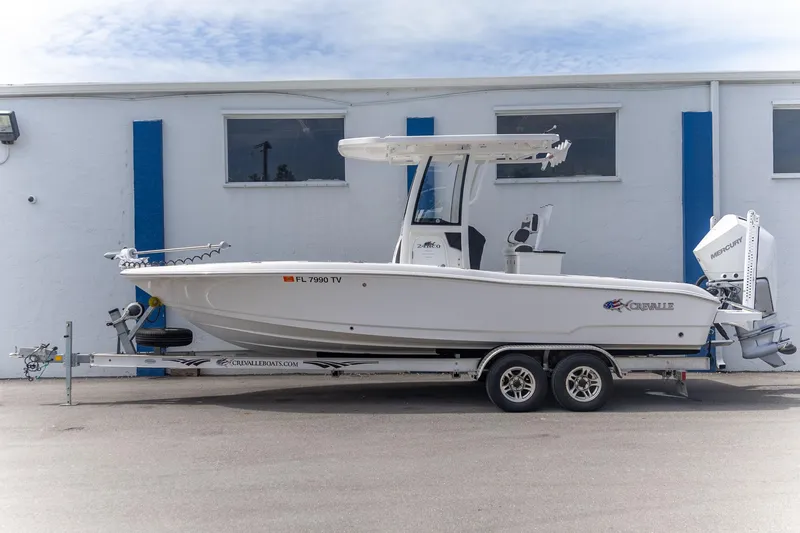 Slide: The Image of 2025 Crevalle 24 HCO boat on trailer, parked beside a building. - 8