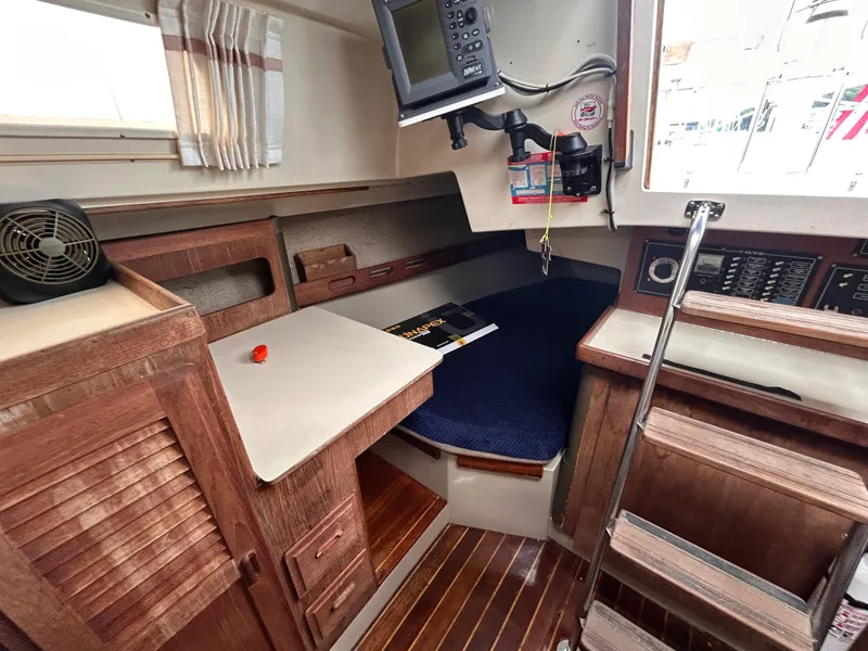 Slide: The Image of 1985 O'Day 35 sailboat interior with navigation equipment and wooden cabinetry. - 14