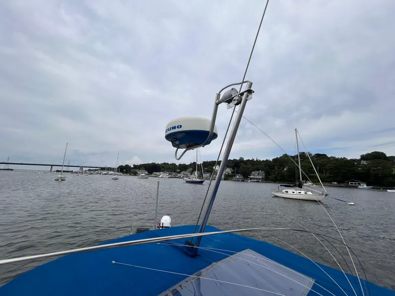 Slide: The Image of 1985 O'Day 35 sailboat on calm water with radar equipment, overcast sky. - 8
