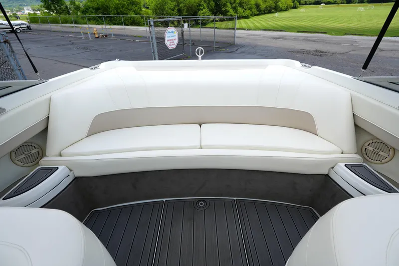 Slide: The Image of Interior of a 1997 Cobalt 232 boat with white seating and gray flooring. - 13