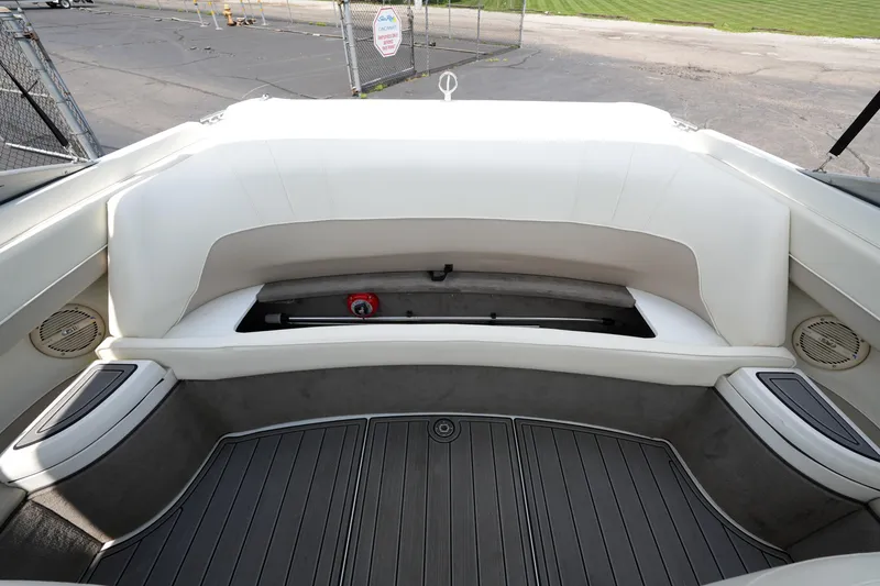 Slide: The Image of 1997 Cobalt 232 boat interior with white seating and storage compartment. - 14