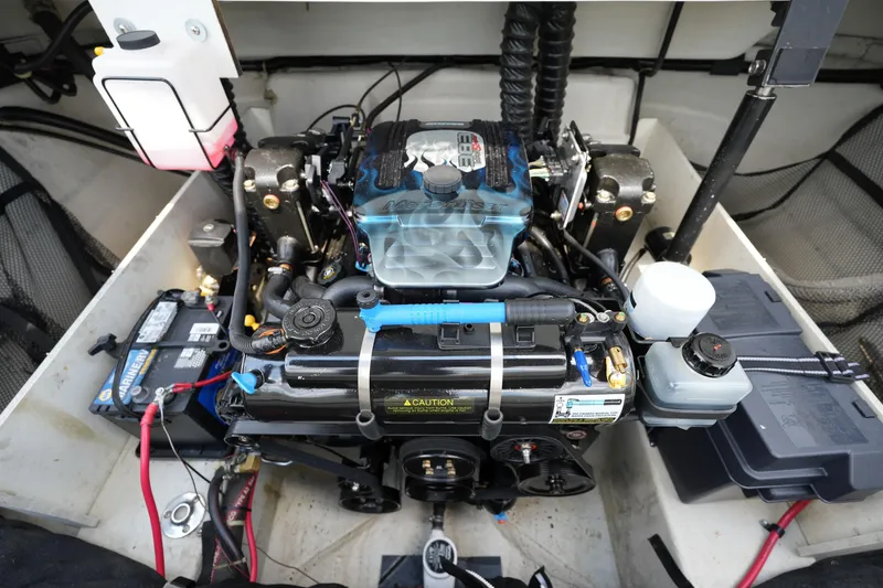 Slide: The Image of Engine compartment of a 1997 Cobalt 232 boat, featuring a well-maintained motor and battery setup. - 15