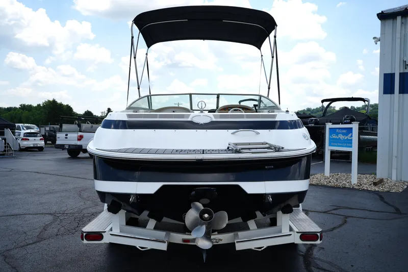 Slide: The Image of Rear view of a 1997 Cobalt 232 boat on a trailer, parked outdoors. - 5