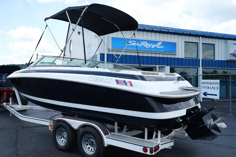 Slide: The Image of 1997 Cobalt 232 boat on trailer outside showroom entrance. - 6