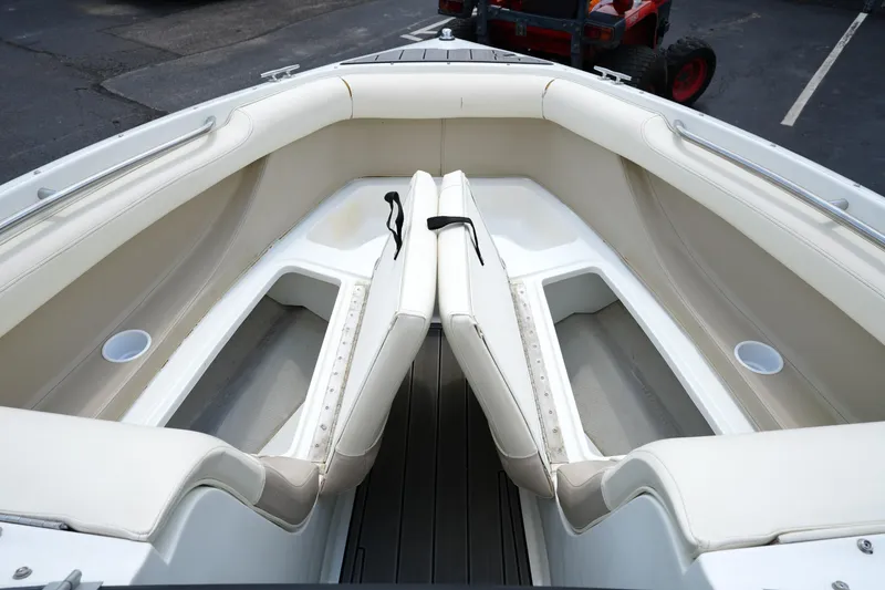 Slide: The Image of Interior of 1997 Cobalt 232 boat with white seating and storage compartments. - 8