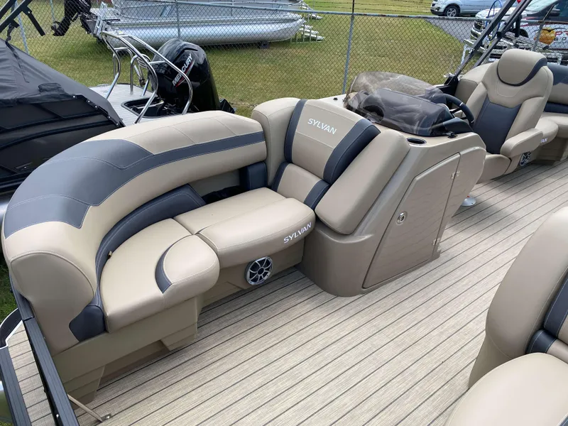 Slide: The Image of 2025 Sylvan L1 LZ Tritoon boat interior with luxurious seating and Mercury 150HP engine. - 12