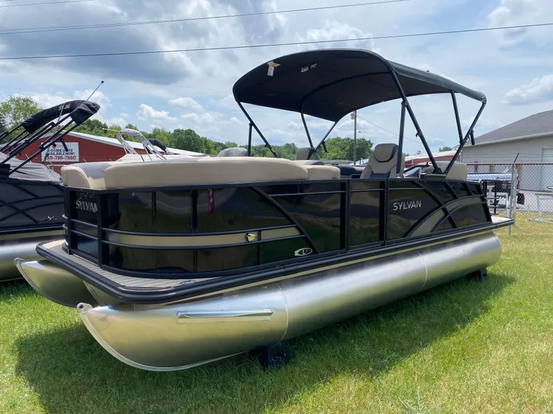 Slide: The Image of 2025 Sylvan L1 LZ Tritoon boat with Mercury 150HP engine on grassy area. - 13