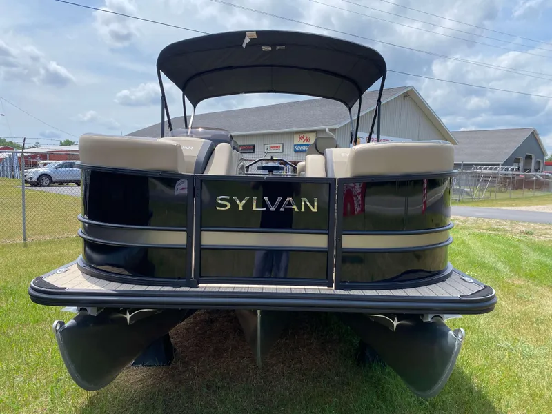Slide: The Image of 2025 Sylvan L1 LZ Tritoon boat with Mercury 150HP engine, parked on grass. - 14