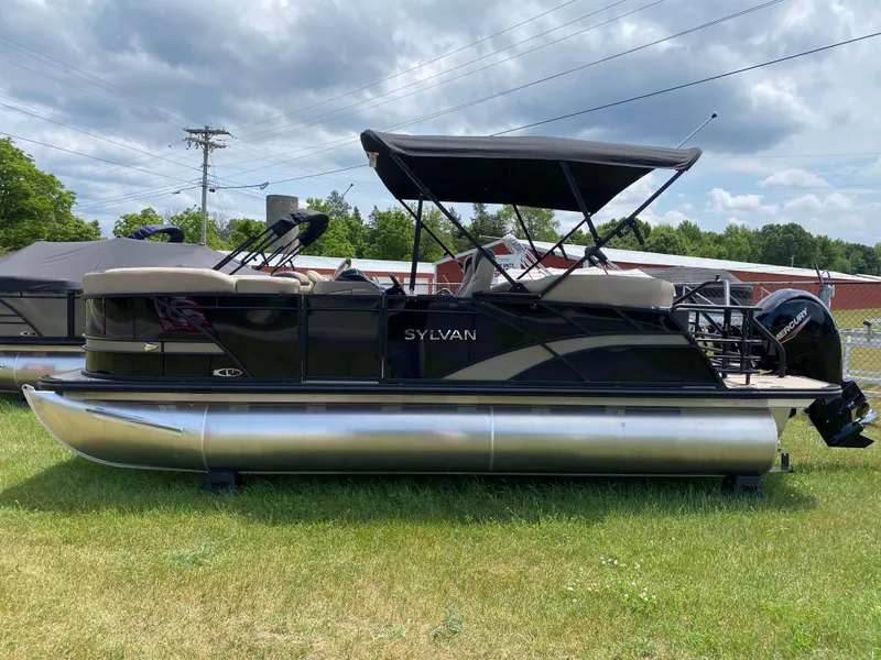 Slide: The Image of 2025 Sylvan L1 LZ Tritoon with Mercury 150HP engine on grassy field. - 17