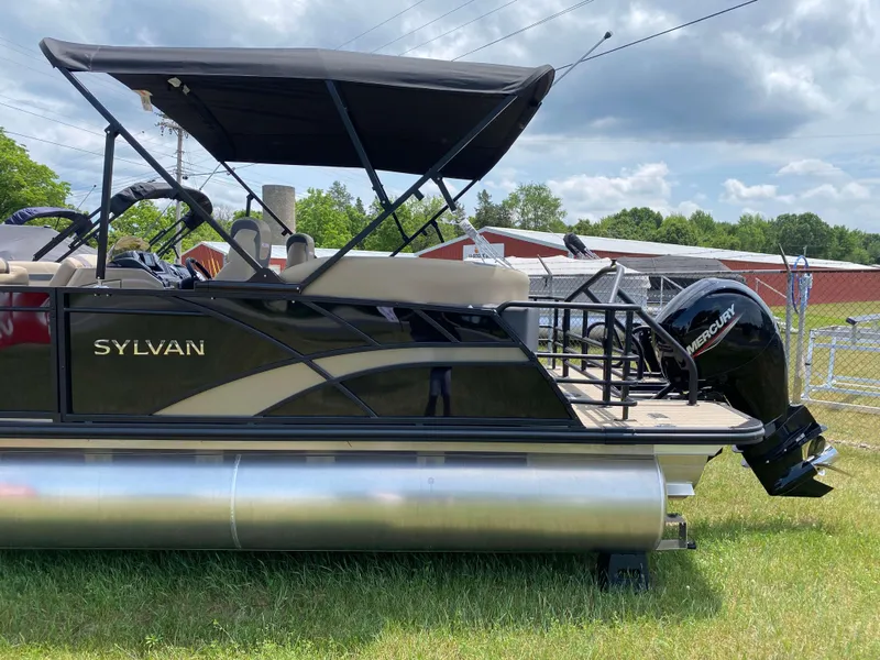 Slide: The Image of 2025 Sylvan L1 LZ Tritoon with Mercury 150HP engine, parked on grass. - 18