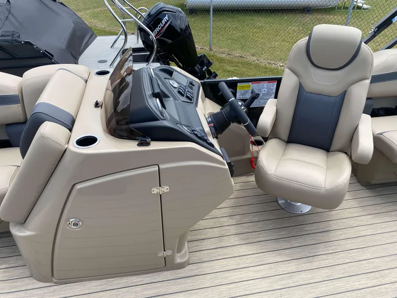 Slide: The Image of 2025 Sylvan L1 LZ Tritoon boat interior with Mercury 150HP engine, featuring beige seating and helm. - 3