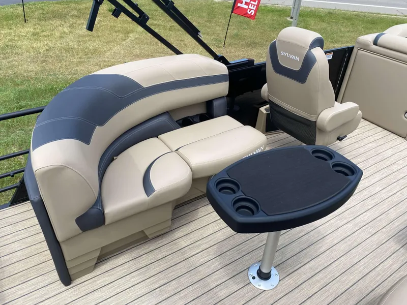Slide: The Image of 2025 Sylvan L1 LZ Tritoon interior with beige seating and table, showcasing luxury design. - 5