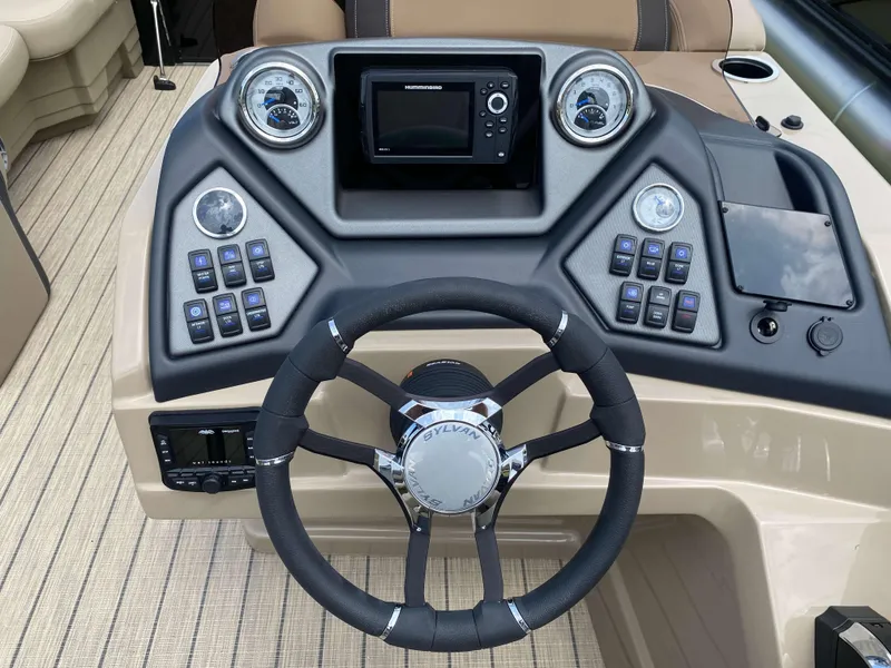 Slide: The Image of 2025 Sylvan L1 LZ Tritoon dashboard with steering wheel and control panel. - 8