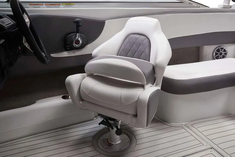 Slide: The Image of 2025 Crownline 220 SS boat interior with plush captain's chair and modern dashboard controls. - 8
