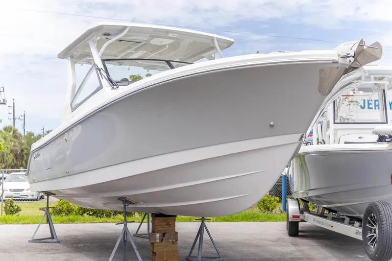 Slide: The Image of 2026 Edgewater 262 CX boat displayed on stands, showcasing sleek design and modern features. - 13