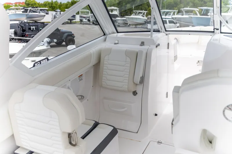 Slide: The Image of Interior of 2026 Edgewater 262 CX boat with white seating and modern design. - 18