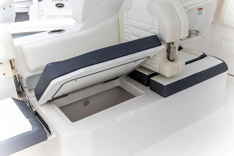 Slide: The Image of 2026 Edgewater 262 CX boat seat with open storage compartment. - 20