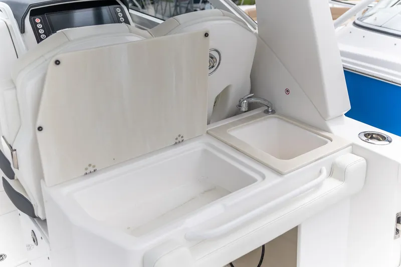 Slide: The Image of 2026 Edgewater 262 CX boat interior with sink and storage area. - 22