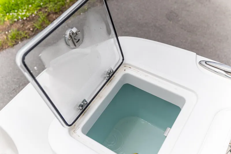 Slide: The Image of Open storage compartment on 2026 Edgewater 262 CX boat, showing interior details. - 23