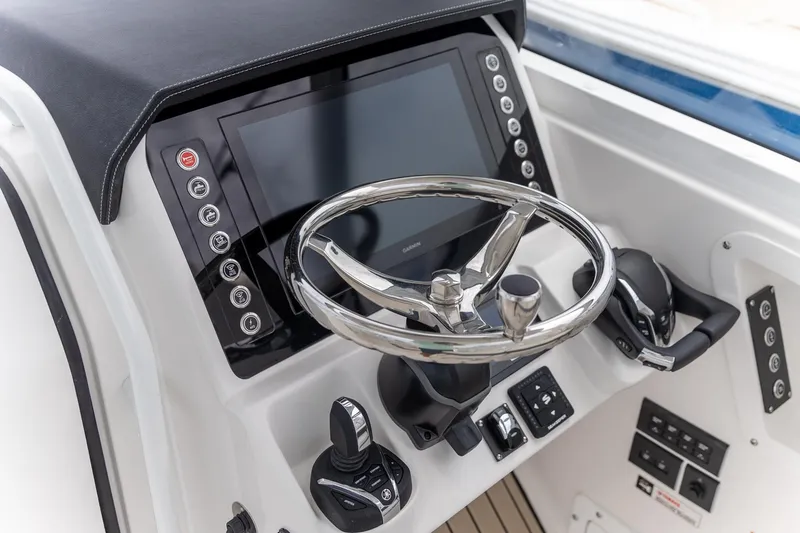 Slide: The Image of Edgewater 262 CX 2026 boat dashboard with steering wheel and control panel. - 25
